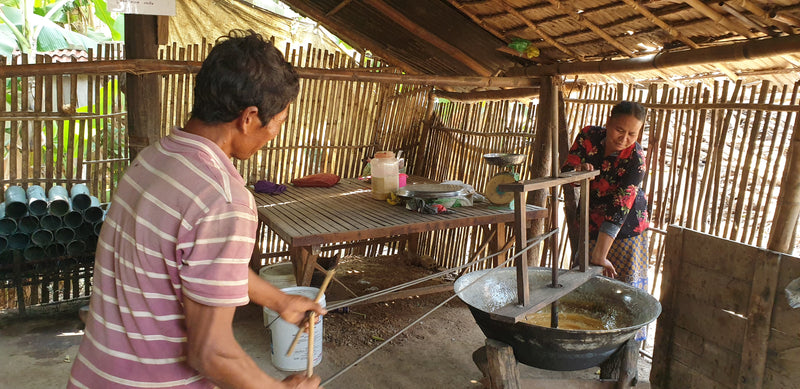 Producers cooking palm sugar sap in a traditional workshop, Kampong Speu